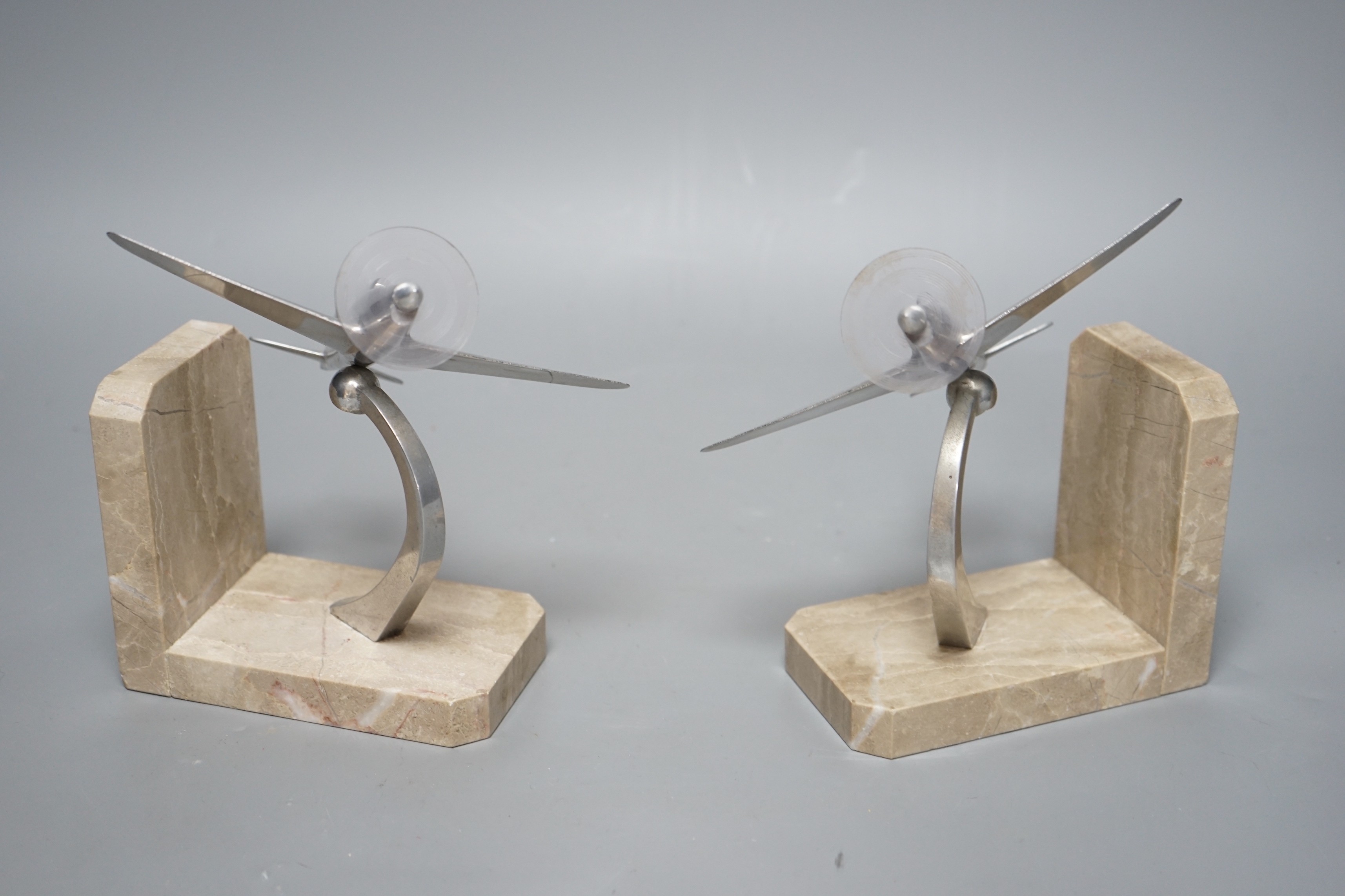 A pair of Art Deco chrome plated and marble aircraft book-ends, 17cm